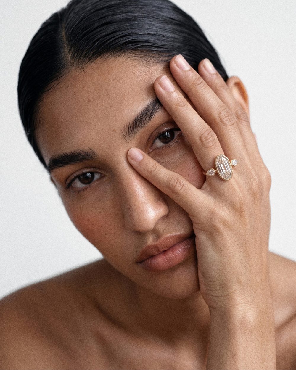 A model wearing a diamond engagement ring