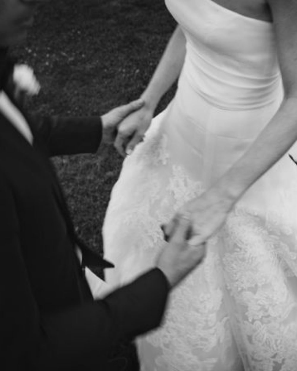 A bride and groom holding hands, black and white photograph